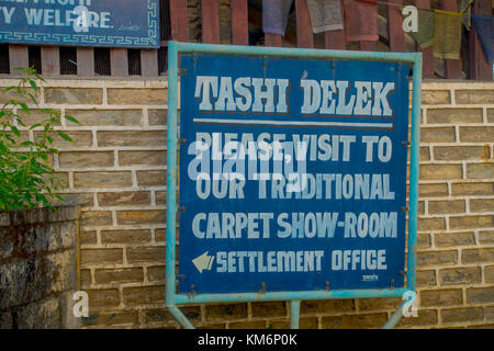 POKHARA, NEPAL - OCTOBER 06 2017: Informative sign of tashi delek, to visit the carpet show room in settlement office in Pokhara, Nepal Stock Photo