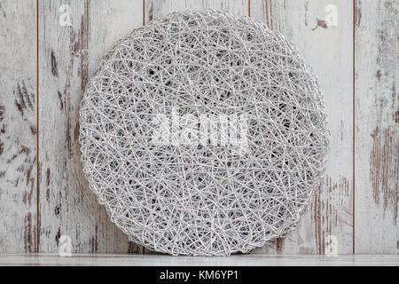 Round American style silver table mat on white wooden background Stock Photo