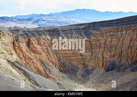 Eroded cliffs and exposed rock strata in Death Valley National Park badlands in an arid barren landscape Stock Photo