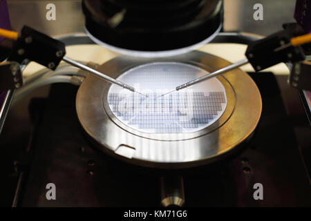 Semiconductor silicon wafer undergoing probe testing. Selective focus. Stock Photo