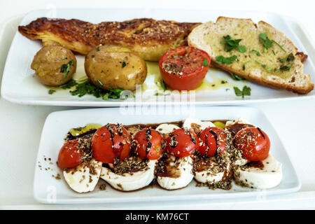 Porto Portugal,Mercado do Bom Sucesso,urban market,food court plaza,dining,plate,Caprese salad,fish,potatoes,garlic bread,restaurant restaurants food Stock Photo