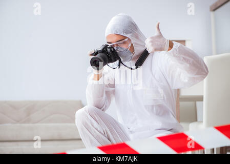 Forensic expert at crime scene doing investigation Stock Photo