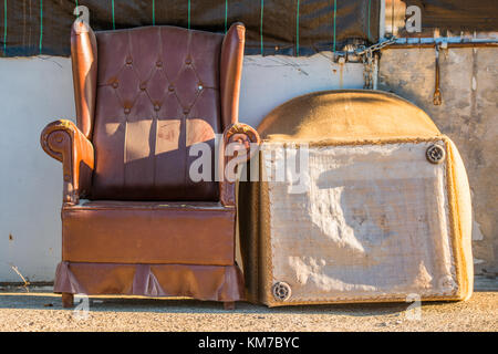 A couple of rickety sofas outside a farmhouse in Jerte, Extremadura, Spain at dusk. Stock Photo