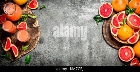 Freshly squeezed grapefruit juice. On rustic background. Stock Photo