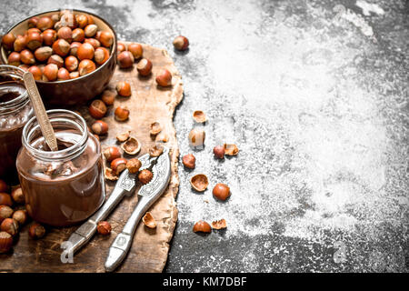 Chocolate butter with hazelnuts. On rustic background. Stock Photo