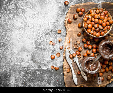 Chocolate butter with hazelnuts. On rustic background. Stock Photo