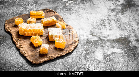 Fresh pieces honeycomb. On a rustic background. Stock Photo