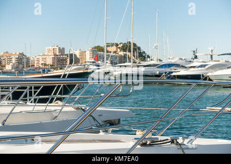 The port of Denia on the Costa Blanca, Spain with luxury yachts, a retail shopping area and bars, restaurants Stock Photo