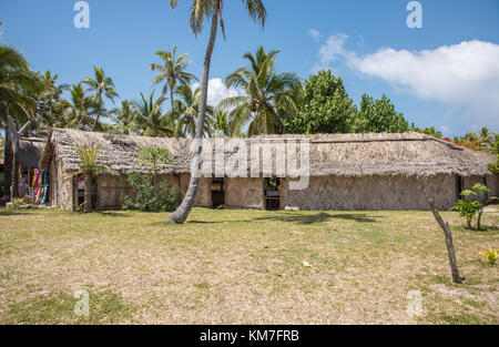 Mystery Island, Vanuatu-December 2,2016: Tourists shopping at market with thatched roof building on tropical Mystery Island, Vanuatu Stock Photo