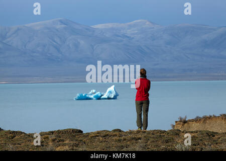 Tourist looking at iceberg in Lago Viedma, Patagonia, Argentina, South America (MR)