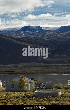 Old corrugated steel farmhouse and small lake near El Chalten, Patagonia, Argentina, South America Stock Photo