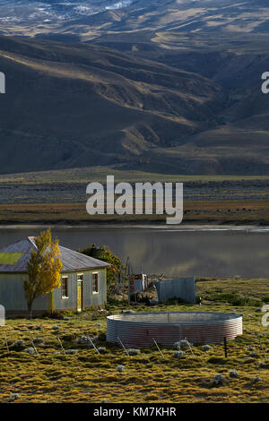 Old corrugated steel farmhouse and small lake near El Chalten, Patagonia, Argentina, South America Stock Photo