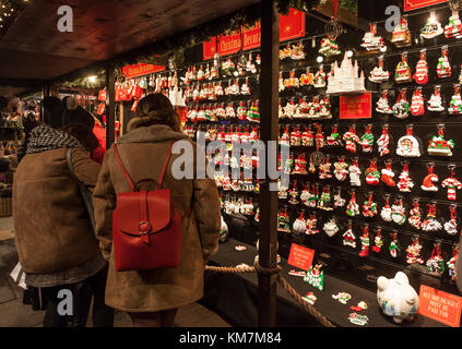 People browsing at a stall selling ceramic Christmas tree decorations in Princes Street Gardens as part of the Edinburgh's Christmas event. Scotland Stock Photo