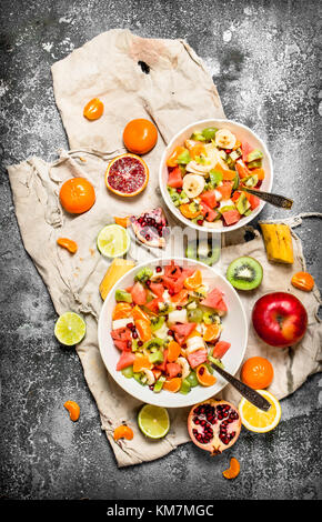 Tropical food . Tropical fruit salad. On rustic background. Stock Photo