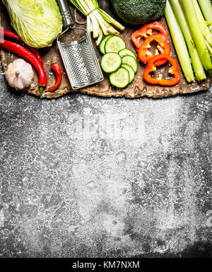 Organic Food. Sliced fresh vegetables. On rustic background. Stock Photo