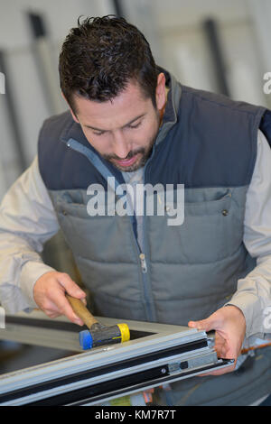 using tools repairing to fix car window Stock Photo