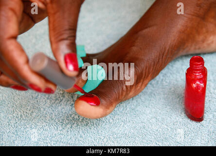 Close up of  woman painting her toenails Stock Photo