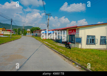 POKHARA, NEPAL - OCTOBER 06 2017: Outdoor view of different buildings with a pavement street, with some cables lines in Pokhara, Nepal Stock Photo