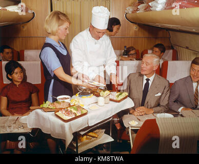 SAS DC 8 33. First Class1969. Interior of cabin, service on board by chef and air hostess Stock Photo
