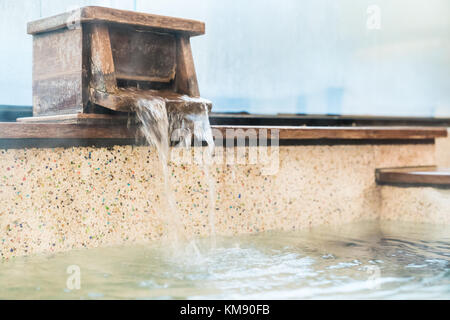 hot spring water come out from bathtub and fill in to the bath. Stock Photo