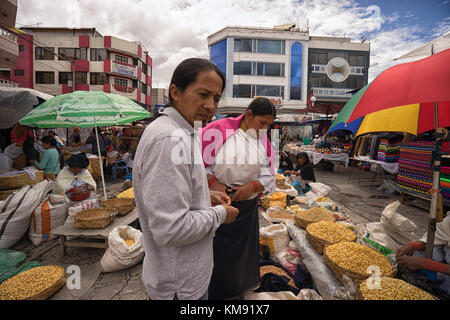 Otavalo, Ecuador - December 2, 2017: indigenous man and woman shopping in the Saturday outdoor artisan and farmer's market Stock Photo