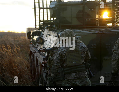 Yavoriv, Ukraine – Ukrainian soldiers assigned to 1st Battalion, 92nd Mechanized Brigade, participate in a platoon live-fire exercise here Dec. 1. During the exercise the unit engaged targets from their BTR-4 armored personnel carriers before dismounting and assaulting the remaining objectives on foot. Stock Photo