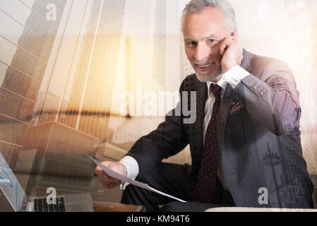 Positive minded entrepreneur having phone conversation Stock Photo