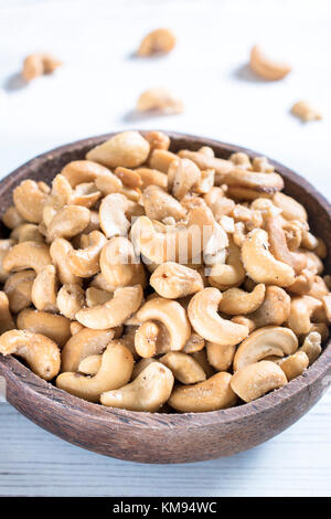Cashew nuts in the wooden bowl,selective focus Stock Photo