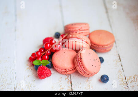 Raspberry Macaroons With Berries On Wooden Table Stock Photo
