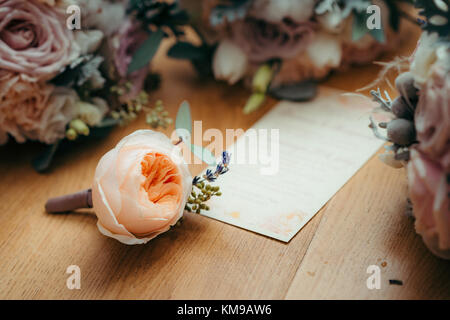 Florish composition. The tender light orange rose is lying on the postcard surrounded by amount of roses. Horizontal view. Stock Photo