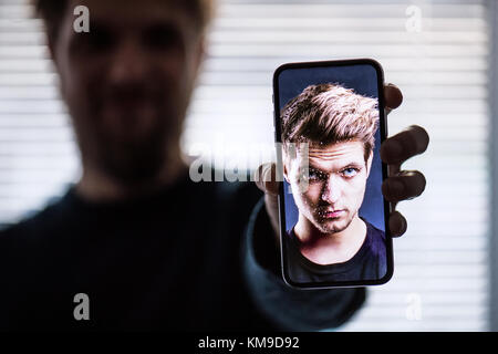 A smartphone using face ID recognition system. Stock Photo