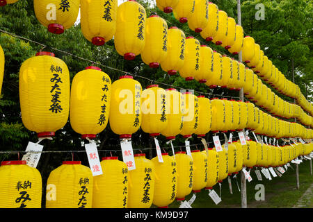 Hiroshima - Japan, May 25, 2017: Yellow lanterns with the names of supporters at the Mantō Mitama Matsuri at the entrance of the Hiroshima Gokoku-jinj Stock Photo