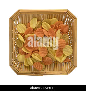 Top view of a square wicker basket filled with vegetable chips isolated on a white background. Stock Photo
