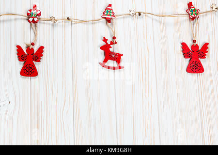 Little Santa stands next to an Armenian wooden Christmas tree toy