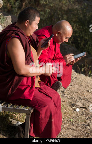 Tibetan monks using smart phones Stock Photo