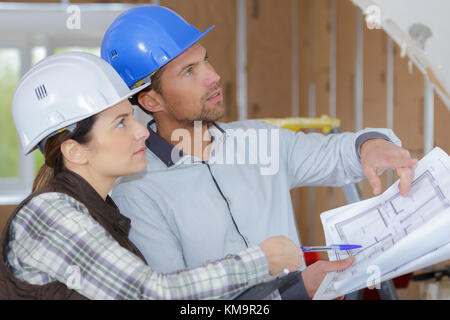 architects  engineers  discussing project at construction site Stock Photo