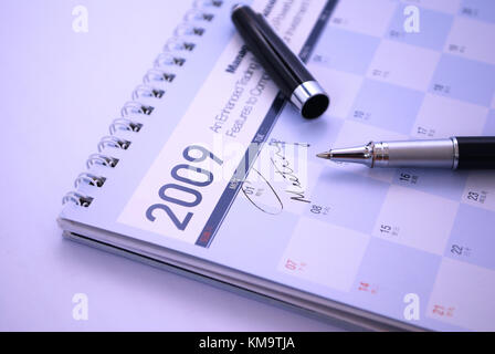Fountain pen and calendar with the date of meeting appointment circled. Suitable for concepts such as business meetings and appointments, executive co Stock Photo