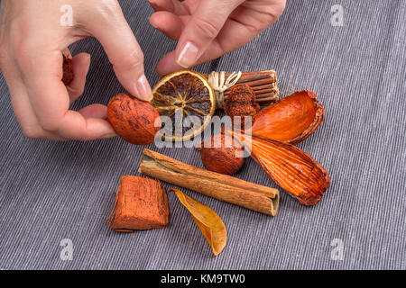 hands making a decoration. stylish rustic winter wallpaper card. space for text. cozy mood winter. seasonal holidays concept Stock Photo