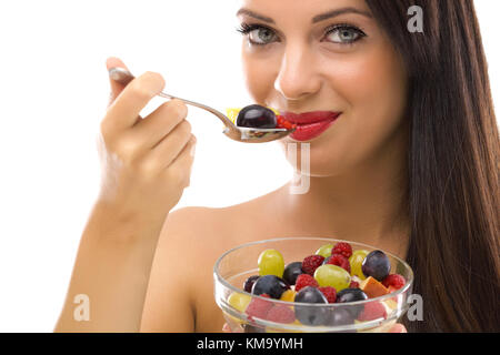 Beautiful young woman eating fresh fruit salad Stock Photo