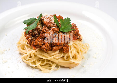 Italian spaghetti pasta with beef and tomato sauce bolognese on white plate Stock Photo