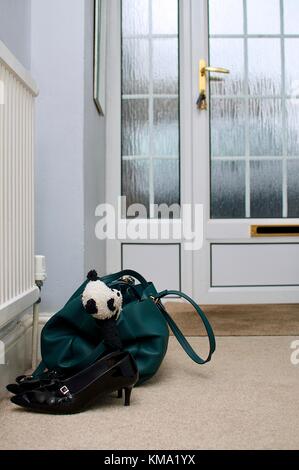 Teddy bear in a woman’s handbag ready to go to work Stock Photo