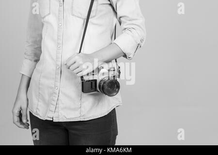 Girl with vintage analog camera. Black and white. Copy space. Stock Photo