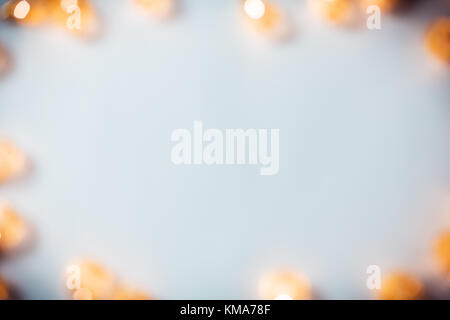 Christmas blurred background with a glowing garland golden bokeh on white. A beautiful holiday idea for postcards and posters. Free space, frame Stock Photo