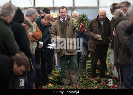 A man auctions wreathes during the annual mistletoe and holly auction at Burford House Garden Stores in Tenbury Wells, Worcestershire. Stock Photo