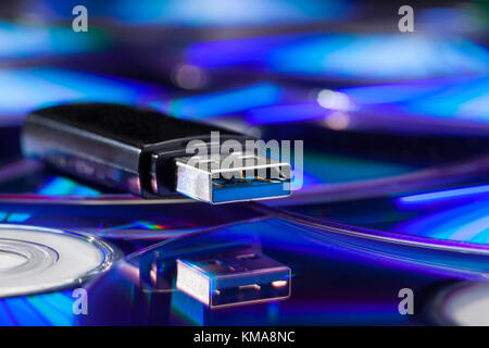 Usb stick and its reflection on a pile of cds Stock Photo