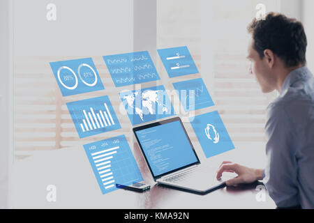 Businessman working with holographic augmented reality (AR) screen technology to analyze business analytics key performance indicator and charts on fi Stock Photo