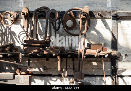 Tools and assorted metal work hanging on the wall of a workshop in Underfall Yard, Bristol Stock Photo
