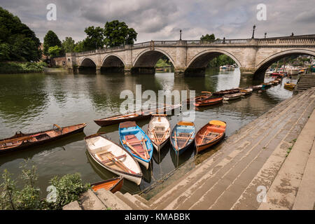 Moored rowing boats with Richmond Bridge in the background, London Stock Photo