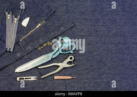 jeans textile with scissors, zipper, chalk, pins Stock Photo