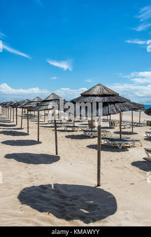 Empty beach with sun loungers and parosols Stock Photo